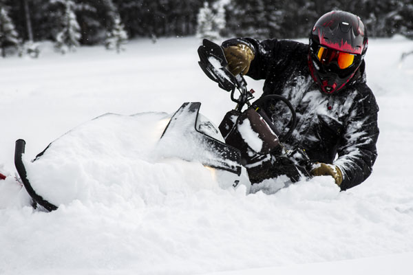 Man using snowmobile in powder snow