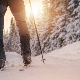 cross country skiing on mountain at sunset