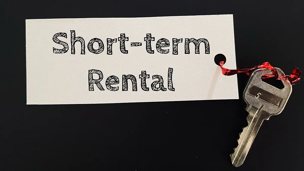 Short term rentals sign with a house key